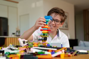 Boy building a tower using NovaBrix bricks