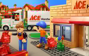 An illustration of two NovaBrix figurinesloading their shopping bags into the back of their car outside a NovaBrix Ace Hardware store.